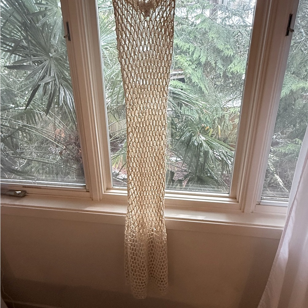 Fish Net long cover up dress form fits to body with some stretch..